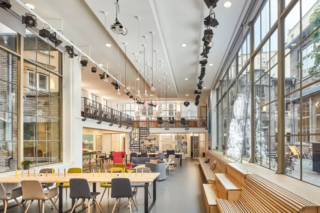A daylit event space under glass — Opero, Prague.