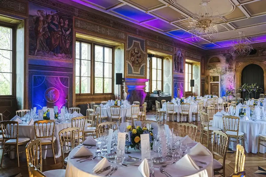 A frescoed hall laid with round tables — Martinic Palace, Prague.